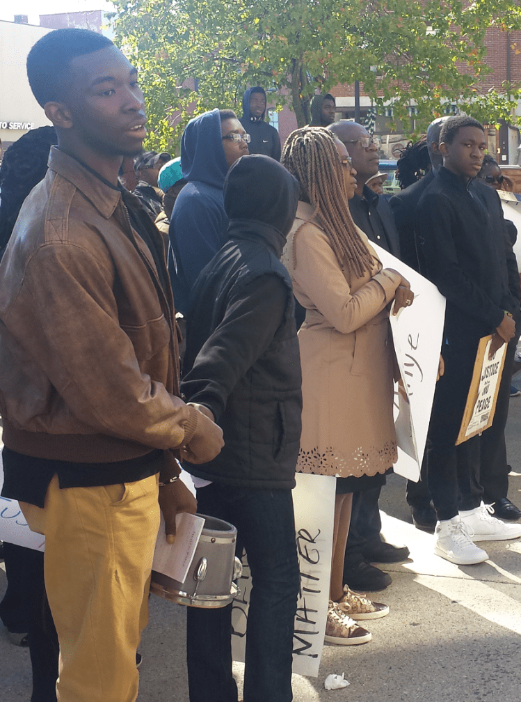 Nkimbeng family stands with supporters in front of City Hall